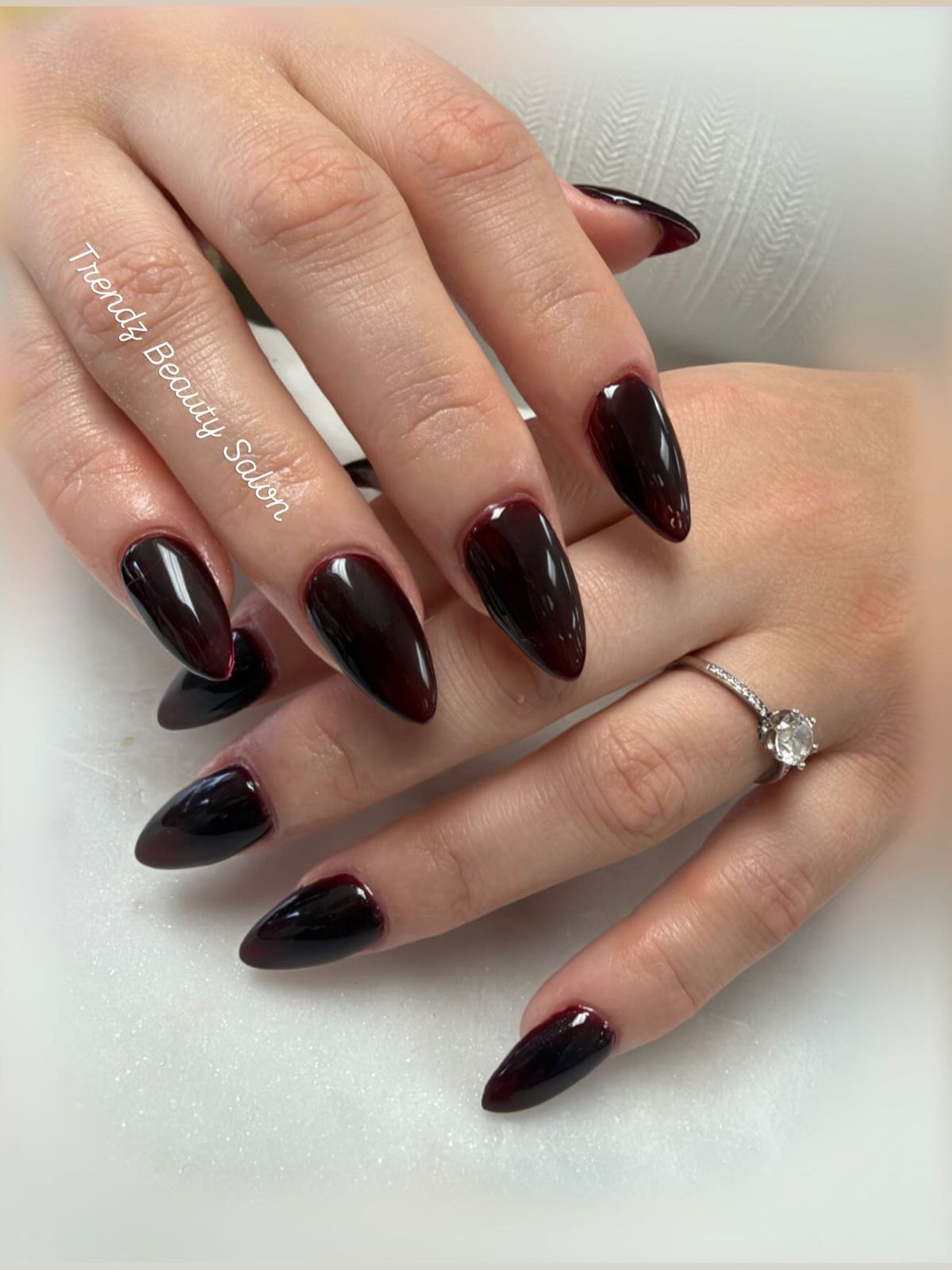 Dark cherry almond-shaped manicure with a glossy finish